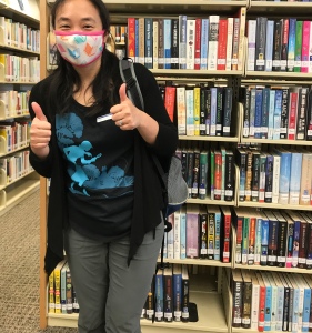 Jennifer at local library with book mask