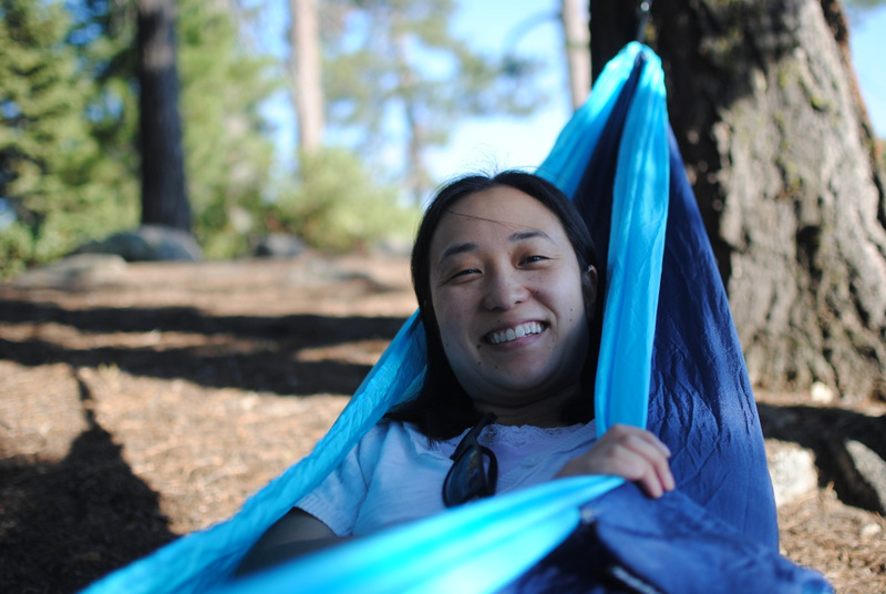 Jennifer Chow sitting up in a blue hammock