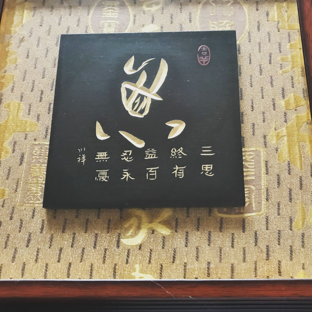 Chinese calligraphy artwork with gold lettering