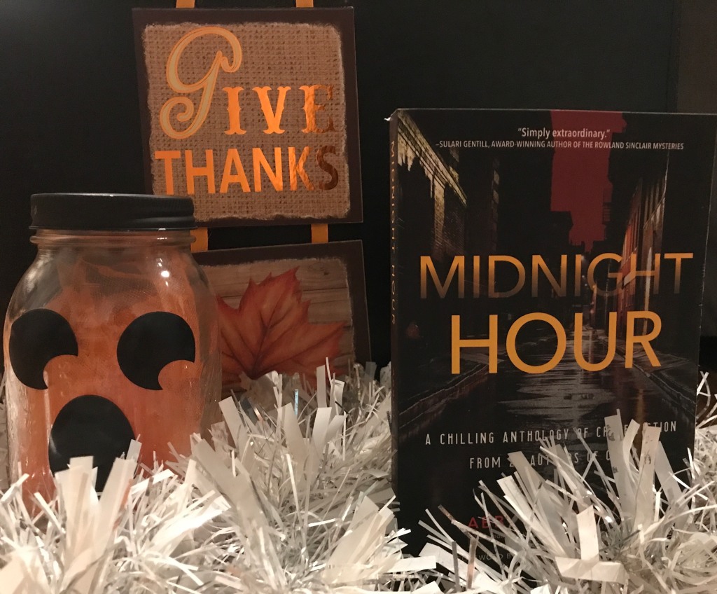 Midnight Hour anthology surrounded by white garland and ghost jar-o-lantern plus "Give thanks" sign