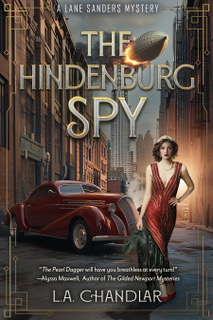 Cover of The Hindenburg Spy by L.A. Chandler. Circa 1930s, woman in red evening gown standing in the street in front of a red car with the cityscape in the background.