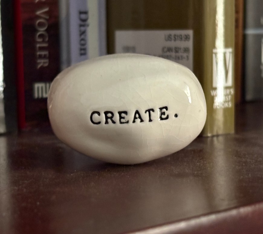 polished stone with the word create typeset into it.