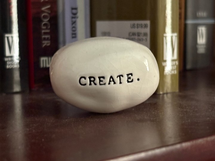 polished stone with the word create typeset into it.